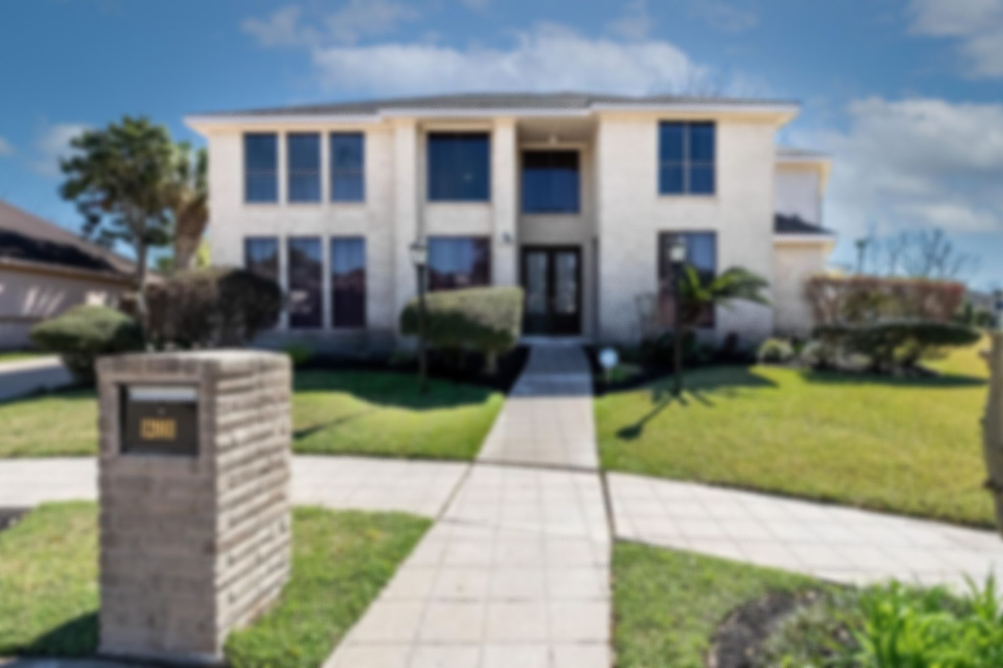 Real estate photography of residential home's exterior front landscaped blurred.